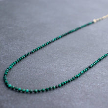 Load image into Gallery viewer, A vibrant green malachite bead necklace with black spinel accents, hand-knotted in a symmetrical pattern, delicately wire wrapped with a 14k gold filled satellite chain.