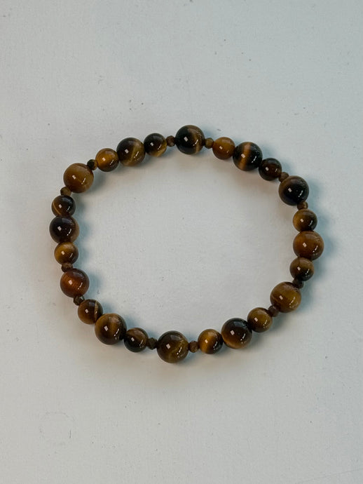 This image features a Confident Leadership Tiger Eye Bracelet, carefully handcrafted with attention to detail. The bracelet is designed with Tiger Eye stones, known for properties promoting confidence, grounding, strength, and mental clarity.